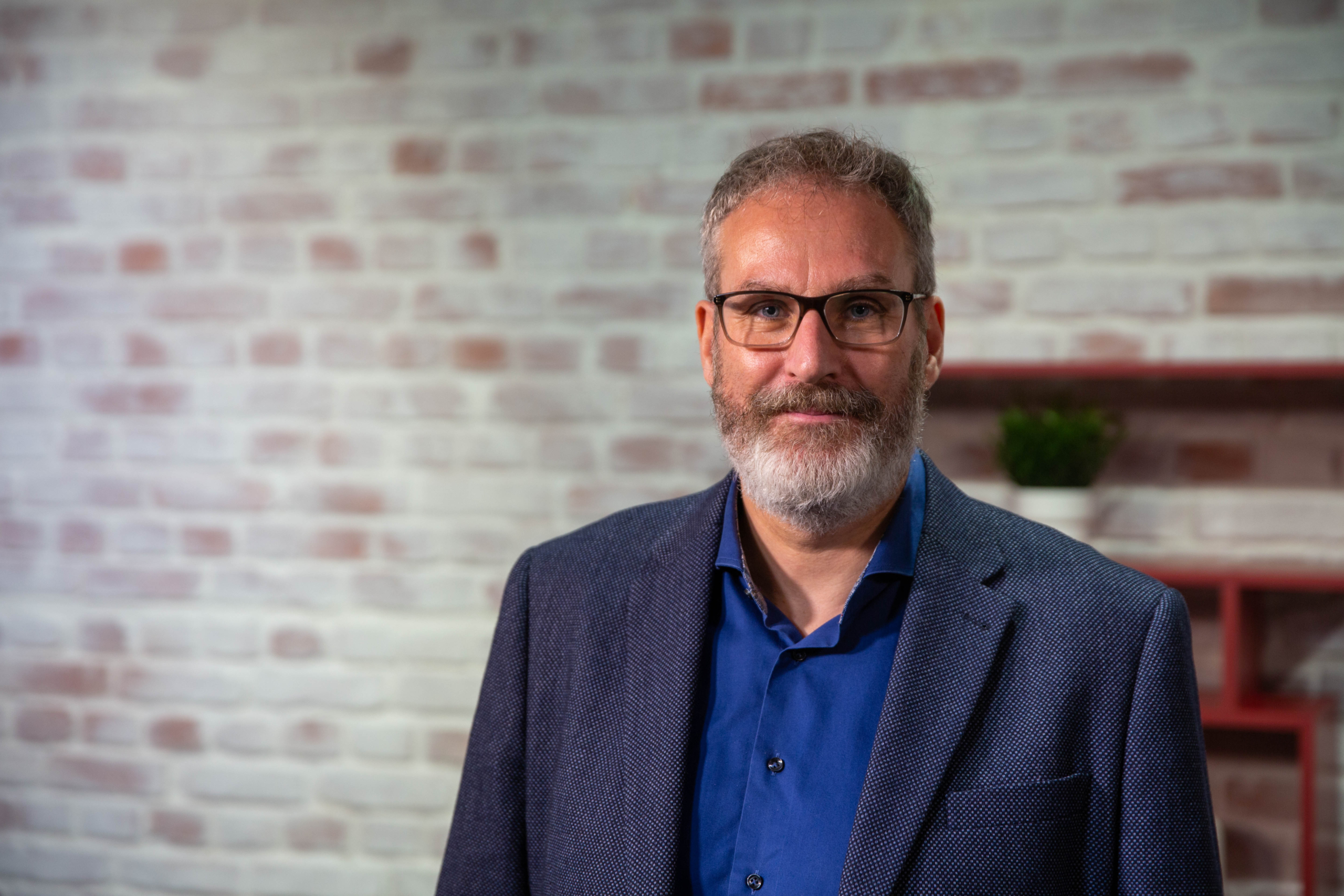 A man wearing glasses posing for the camera
