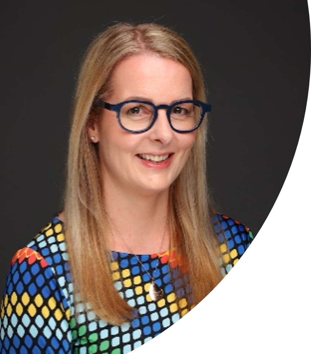Di Mayze, a smiling woman with blonde hair and glasses.