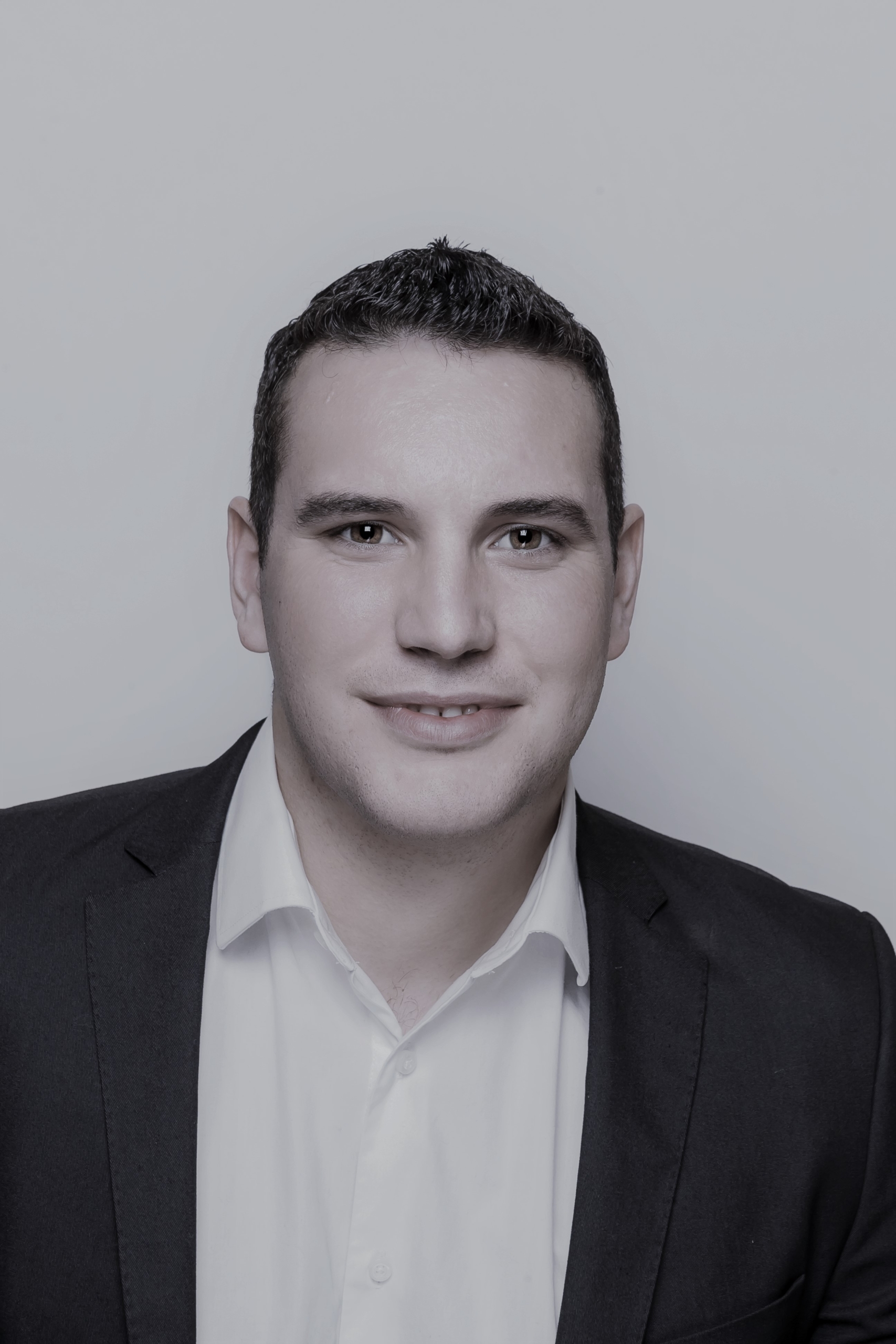 Dan Cousineau, a man in business suit smiling at the camera.