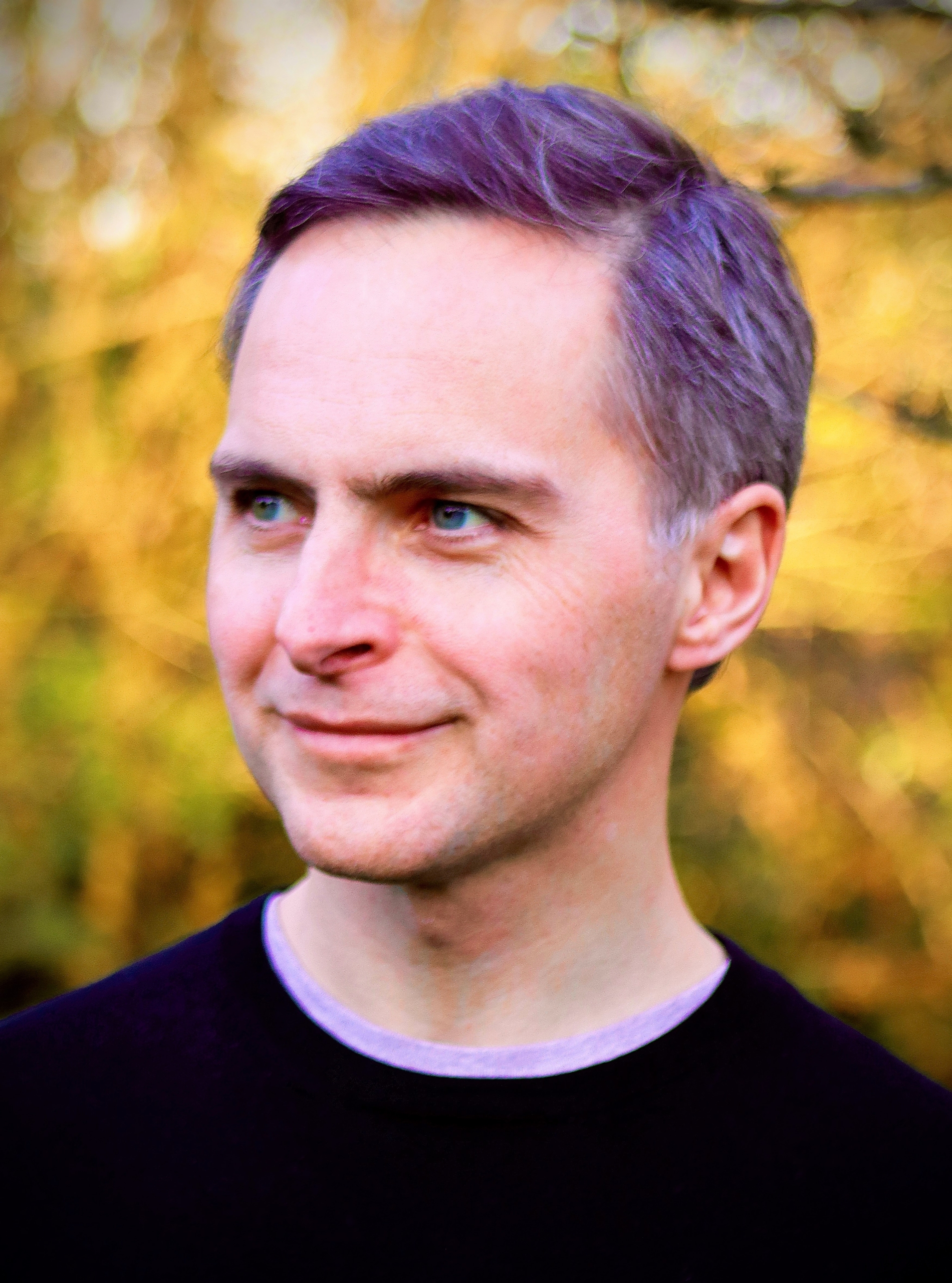 Terry Room smiling, focussing in the distance off-camera.