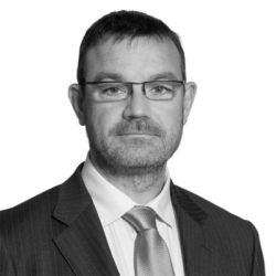 Nathan Hayes, a man wearing a suit and tie smiling at the camera