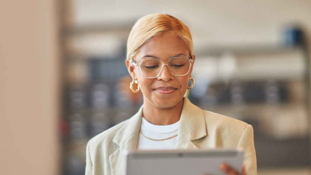 Person looking down at a tablet and smiling