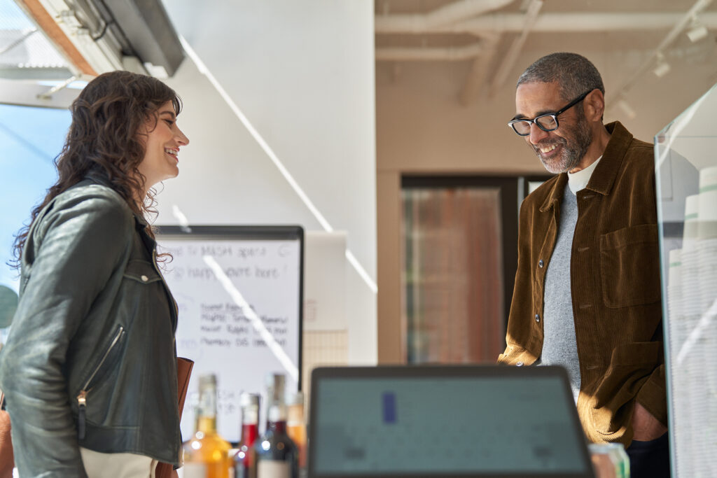 a man and a woman looking at a computer screen