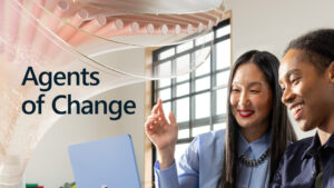 A woman sitting at a desk with a laptop