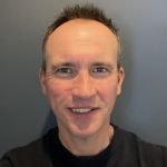 Portrait image of Darren Spence, CRO of Smartbox.ai, smiling at the camera.