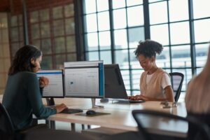 Two women working at computers