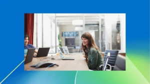 A group of people sitting at a table with laptops