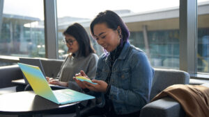 Two security workers sit at laptops.