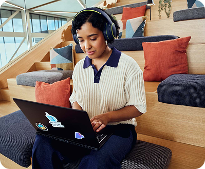 A woman wearing headphones, focused on listening, with a serene expression on her face.