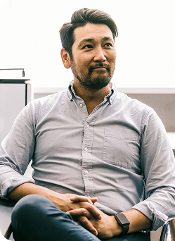 A man with crossed arms sitting in an office chair, displaying a thoughtful expression.