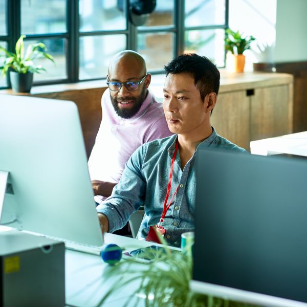 Two people using Microsoft Copilot Studio collaborate in an office setting.