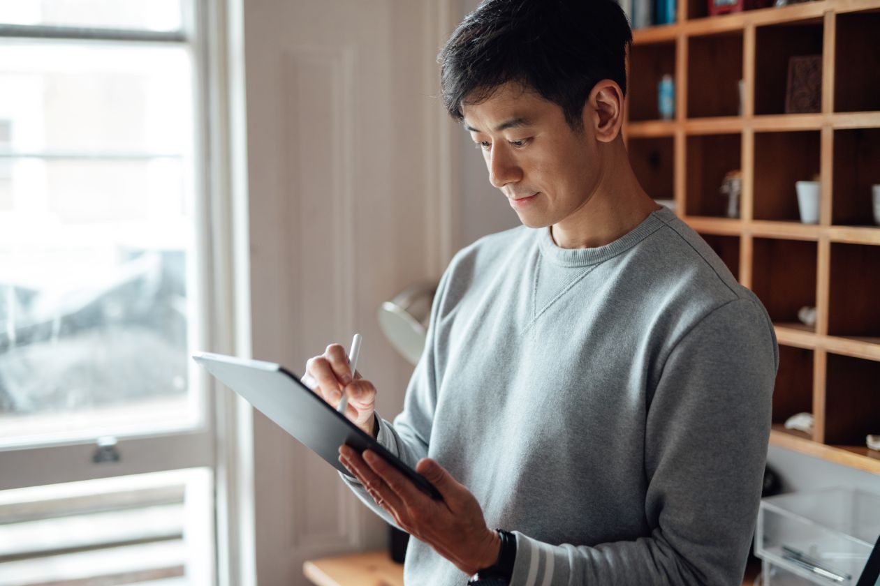 Man operating AI agent on tablet