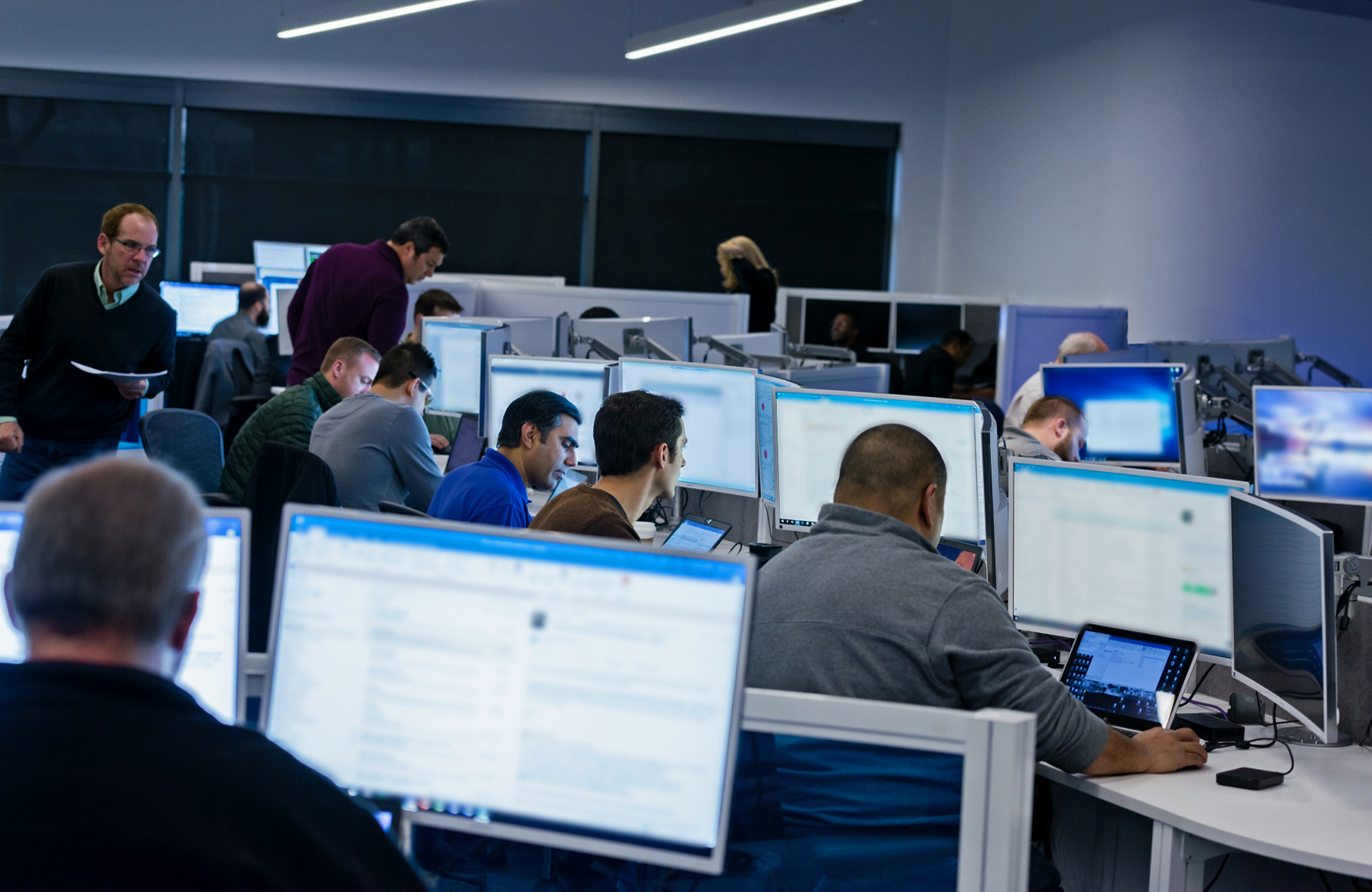 Group of people sitting at desks working in an office