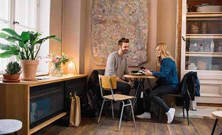 Image of a couple looking over a purchase on a mobile device