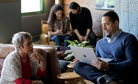 Image of two workers collaborating in a workspace