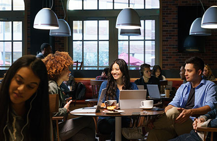 Image of a group of firstline workers working around a coffee table