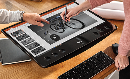 An image of two workers collaborating on a model of a bicycle with ink in PowerPoint