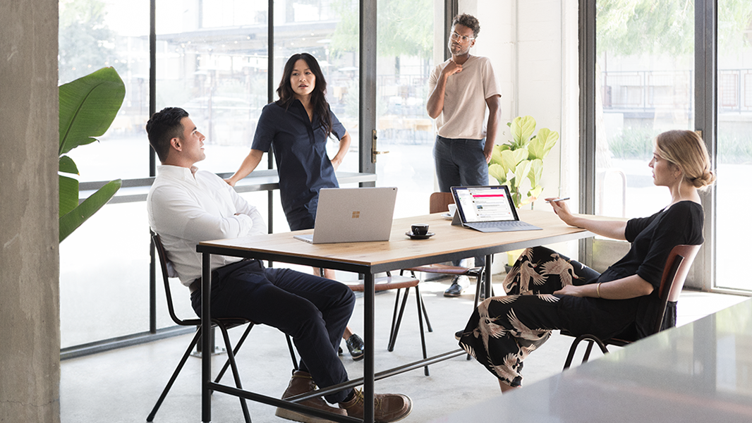 Image of a team of four firstline workers collaborating around a table