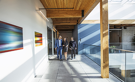 Image of three coworkers walking along a hallway