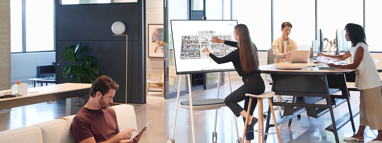 Image of four workers collaborating in a lounge