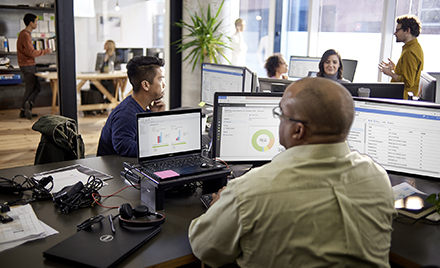 Image of an office of tech workers using Microsoft Office products