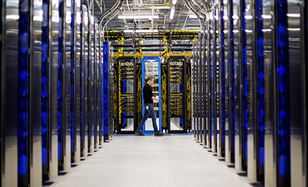 Image of a man walking through a datacenter