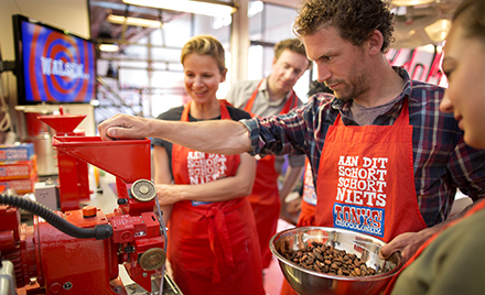 Image of a worker scooping chocolate at Tonys Chocolonely