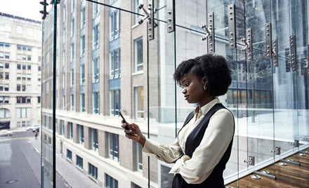 Image of a worker checking her phone