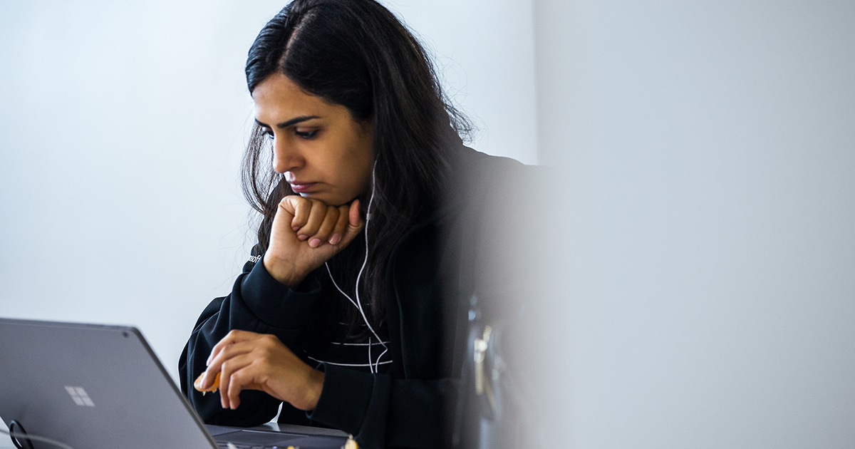Image of a developer working remotely on her laptop