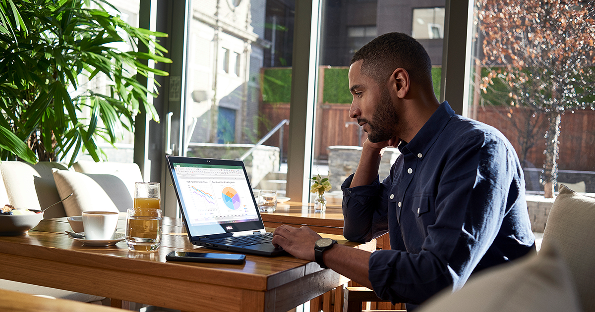 Image of a remote worker working at his desk. An Excel spreadsheet is open