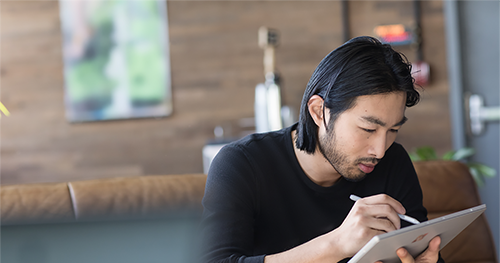 Image of a small business male with a Surface in modern workplace