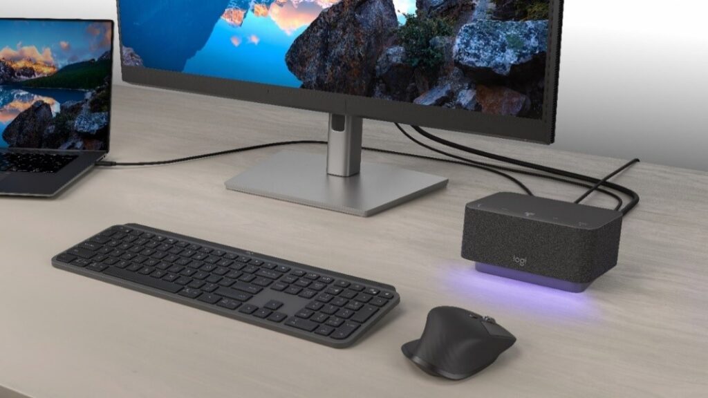A Logi Dock on a desk with a laptop, computer monitor, mouse, and keyboard. 