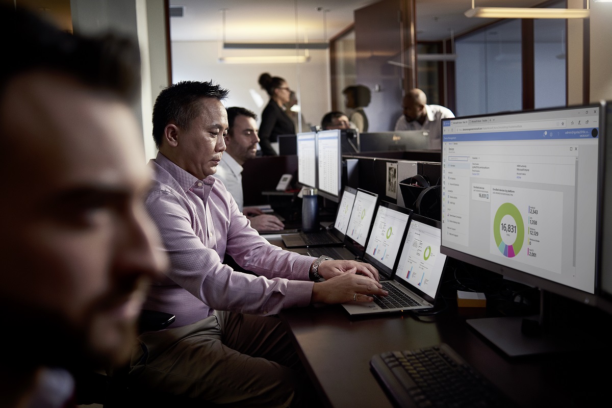 IT employees working on multiple screens