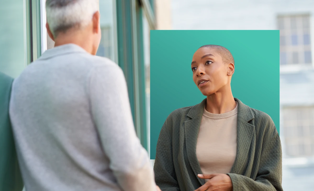 A female person talking to a male person outdoors