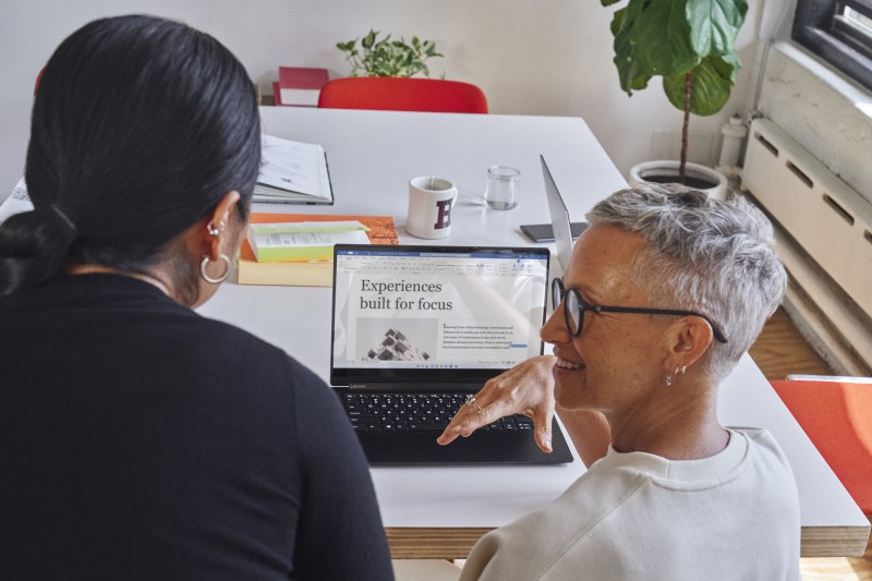 Windows contextual imagery of adult females inside collaborating on Windows 11 PC in Microsoft Word