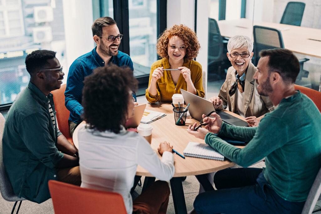 Group of people sitting together at a table talking