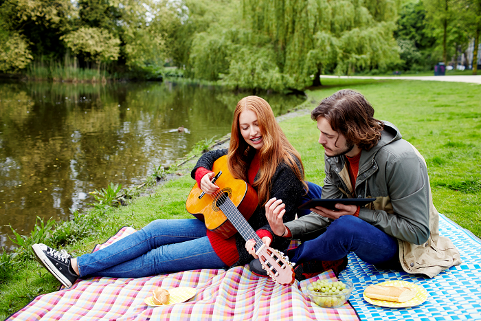 a group of people sitting in the grass
