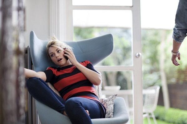a woman sitting on a chair next to a window
