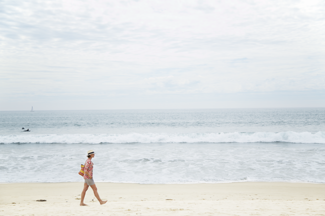 a person standing on top of a sandy beach