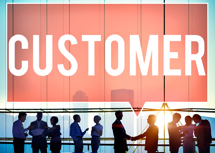 a group of people standing in front of a sign