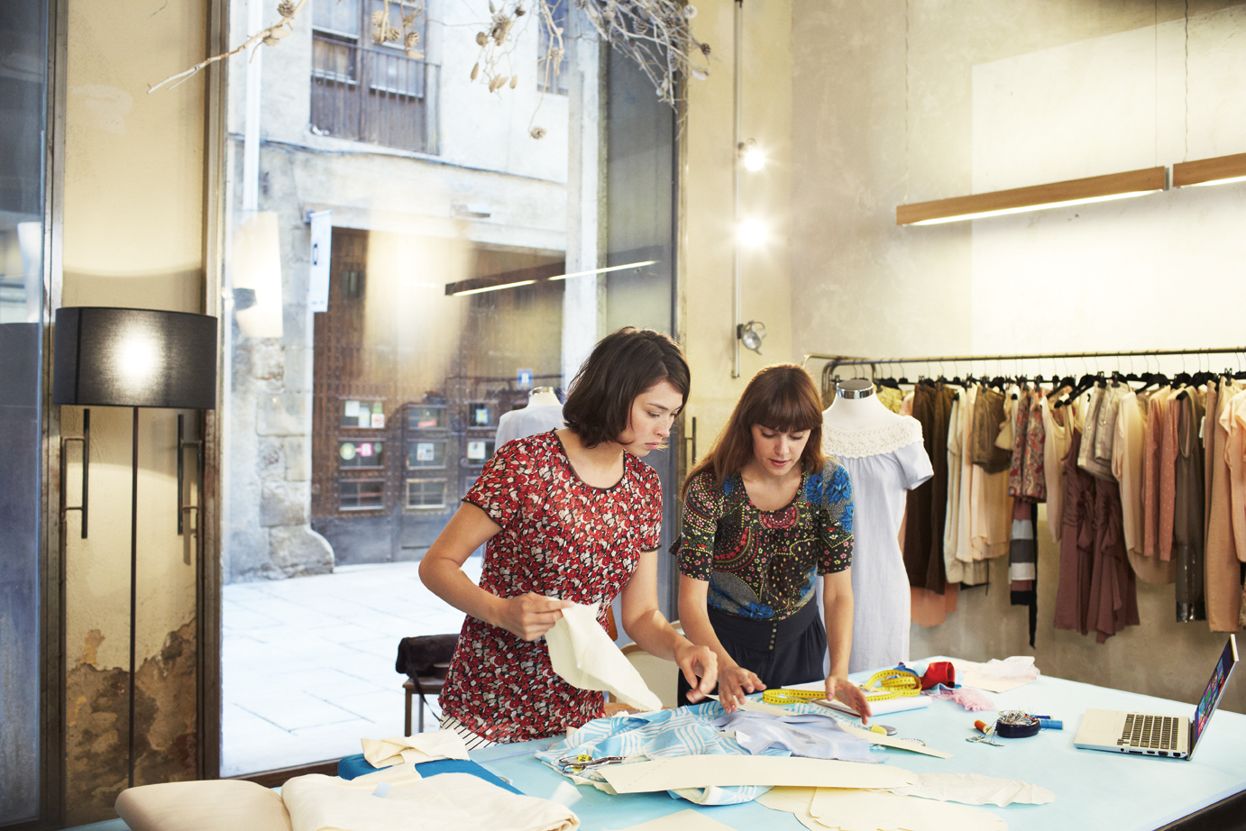 a group of people sitting at a table with a cake