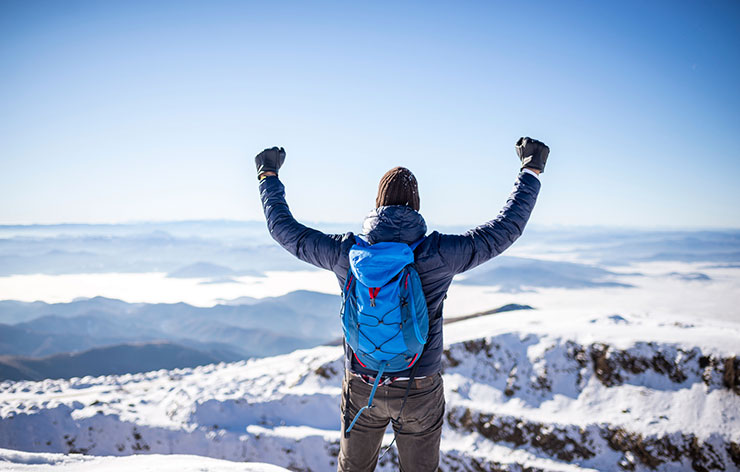 a person standing on top of a snow covered field