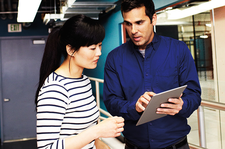 a group of people looking at a laptop