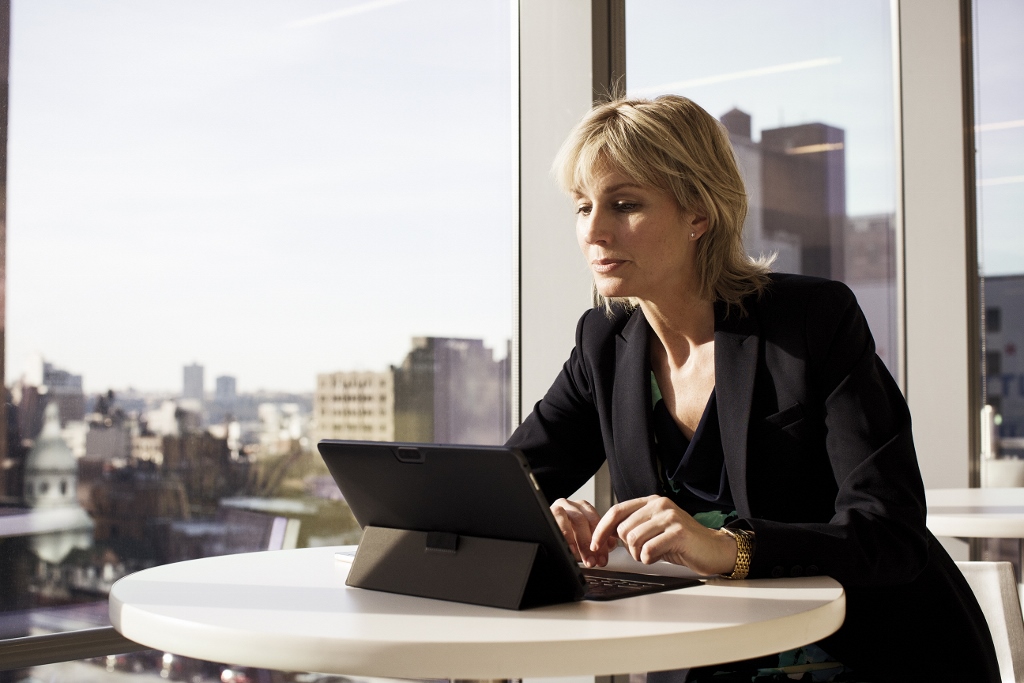 a woman standing in front of a computer