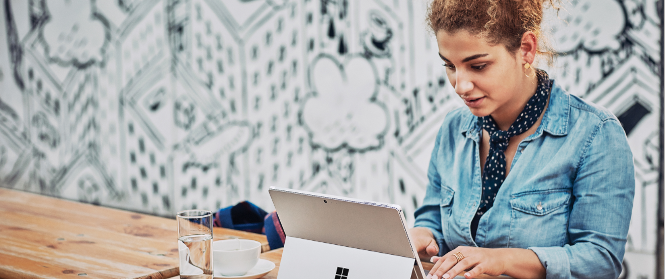 a woman sitting in front of a laptop computer