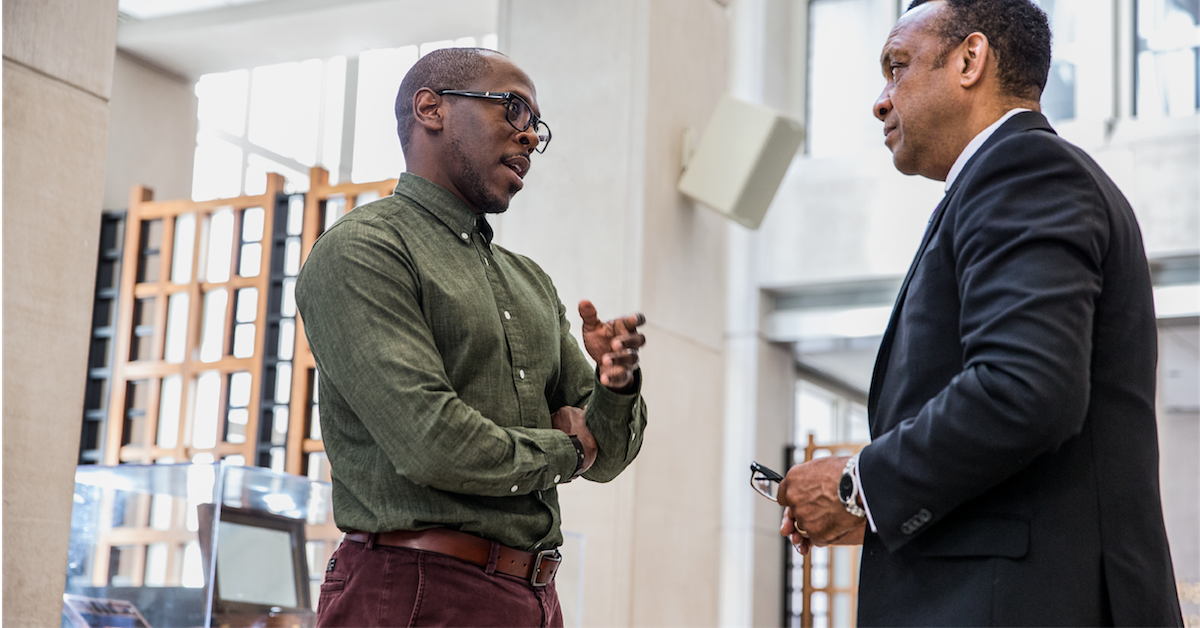 a man standing next to a building