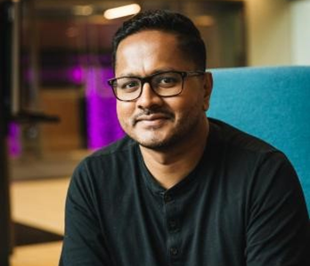 A man wearing glasses and a black shirt