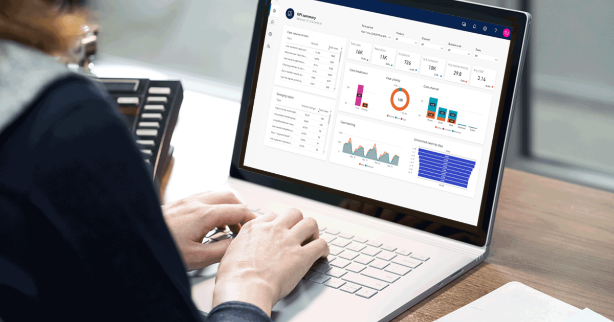 a group of people sitting at a table using a laptop