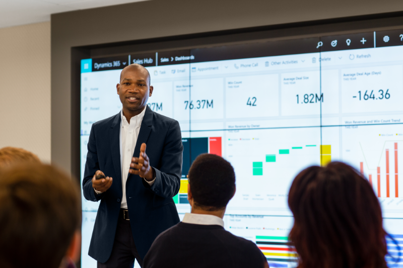 a group of people looking at a screen