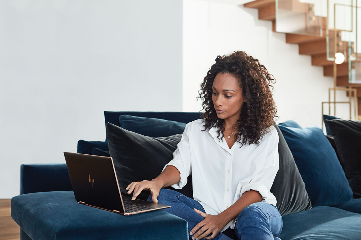 Adult inside home working. Back to school. HP Spectre X360